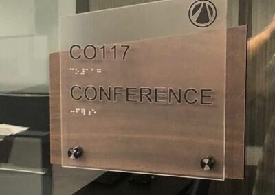 An asymmetric conference room sign that is ADA compliant