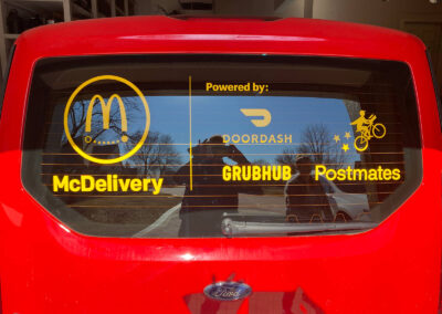 Vinyl window decals on a McDelivery car