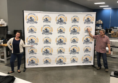 Step and repeat banner backdrop showcasing the logo for Old Settlers Day